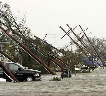 Power poles are pushed over in a flooded street after Hurricane Katrina struck Gretna, Louisiana August 29, 2005.