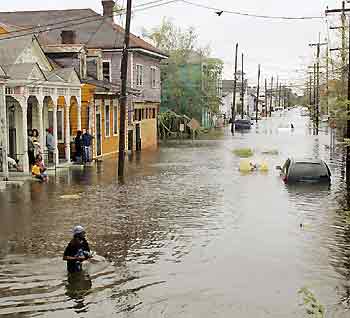 A man walks through the flooded Terme area of New Orleans, lying under several feet of water after Hurricane Katrina hit August 29, 2005. Hurricane Katrina ripped into the U.S. Gulf Coast on Monday, battering the historic jazz city New Orleans, swamping resort towns and lowlands with a crushing surge of seawater and stranding people on rooftops. REUTERS