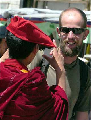 A European tourist talks with a lama on a street in Lhasa, capital of southwest China's Tibet Autonomous Region, August 30, 2005. During the 2005 Europe-China Tourism Forum held recently in Switzerland, Lhasa was appraised as European tourists' most favorite tourism destination, and the Potala Palace in central Lhasa was listed as European tourists' most favorite scenic spot. [People's Daily]