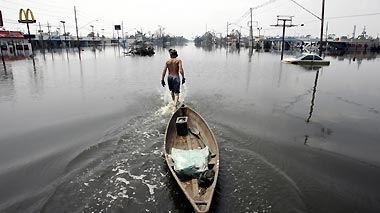 Hurricane Katrina survivor Paul Metzler pulls his boat along Paris St in Chalmette, a community about 7 miles (11 km) east of New Orleans, September 3, 2005. For the first time since Hurricane Katrina struck on August 29, rescuers are scouring the community for survivors.