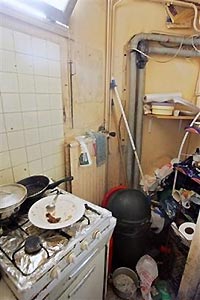 A view of a cooking installation, with electric wiring and sewage disposal in background, in a squatted building in the 19th district of Paris, after it was evacuated by police forces, Friday, Sept. 2, 2005. Paris police on Friday evacuated about 140 people from buildings deemed dangerous fire hazards, responding to a new Interior Ministry order to shut down all havens for squatters, following two recent fires that killed two dozen African immigrants in the French capital and put the issue of substandard housing on the national agenda.