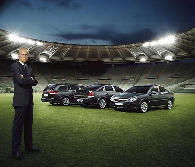Italian referee Pierluigi Collina poses in front of Opel cars in a promotional photograph released by the auto maker August 29, 2005. The sudden resignation of referee Pierluigi Collina has left many Italians debating whether soccer's best-known match official was forced to quit. The five-times world referee of the year resigned from the Italian Association of Referees (AIA) on Monday after refusing to renounce an 800,000-euros per year sponsorship deal with German car manufacturer Opel. Picture released August 29, 2005. [Reuters]
