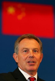 British Prime Minister Tony Blair delivers a speech under a Chinese flag during the EU-China Business Summit at the Great Hall of the People in Beijing, Monday, Sept. 5, 2005. 