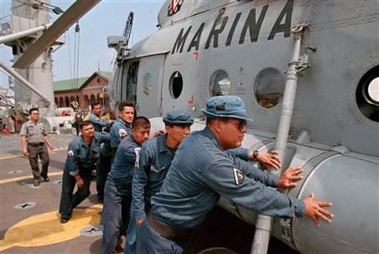 Mexican navy sailors get a helicopter into position on the deck of the Mexican Navy ship Papaloapan in the port city of Tampico, Mexico, Monday, Sept. 5, 2005. The Papaloapan, carrying rescue vehicles and helicopters to aid the victims of the hurricane Katrina in the U.S., left port on Monday for the Mississippi coast. (AP