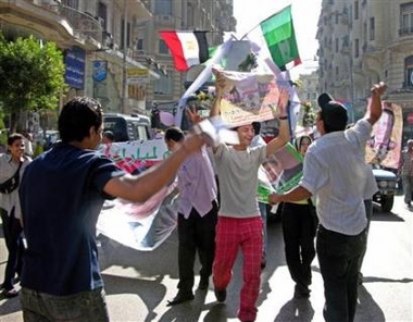 Supporters of Egyptian President Hosni Mubarak sing and dance in a Cairo street September 7, 2005. Polling stations opened for Egypt's first presidential elections, with President Hosni Mubarak expected to win a fifth six-year term as the leader of the Arab world's most populous nation.