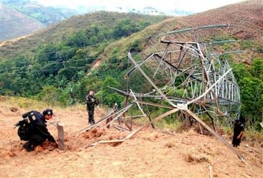 Three police officers check a power tower destroyed by alleged rebels of the Revolutionary Armed forces of Colombia, FARC, in a rural area of Piendamo, in the Cauca state, some 210 southwest of Bogota, Colombia, Monday,Sept.5,2005.