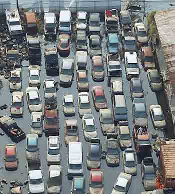 A parking lot full of abandoned cars sit in water, oil, and sewage in the Parish of St. Bernard in New Orleans, Louisiana, September 10, 2005. [Reuters]