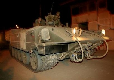 An Israeli army armored vehicle leaves the Gaza Strip through the Kerem Shalom Crossing into Israel early Monday, Sept. 12, 2005.