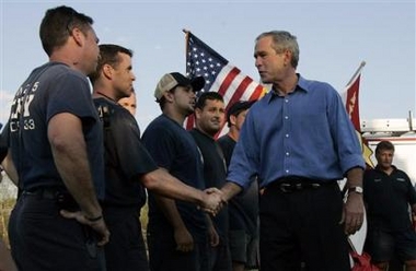 President Bush meets members of the New York City fire department at a first-responders base camp in Algiers, La., on the outskirts of New Orleans, Sunday, Sept. 11, 2005.