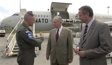 Czech Foreign Minister Cyril Svoboda, left, and U.S. ambassador to the Czech Republic William Cabaniss, centre, talk with one of the pilots of NATO's Boeing 707 cargo plane based in Geilenkirchen, Germany, that landed at Ruzyne airport in Prague for the first part of Czech humanitarian aid for survivors of the hurricane Katrina in the United States on Sunday, Sept. 11, 2005. 