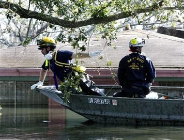 Members of a San Diego search and rescue team move along floodwaters in their boat on Sunday, Sept. 11, 2005, in New Orleans. (AP