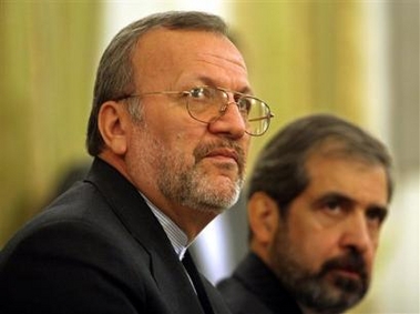 Iranian Foreign Minister, Manuchehr Mottaki, left, listens to a question, next to Foreign Ministry spokesman, Hamid Reza Asefi, during a press conference in Tehran, Iran, Sunday, Sept. 11, 2005.