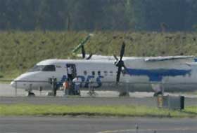 Passangers of a hijacked Colombian airliner leave the plane parked at the tarmac of the Bogota's El Dorado airport, Monday, Sept 12, 2005.