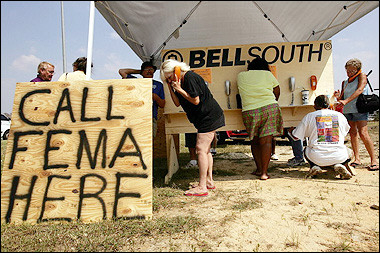 People use phones at a mobile phone center to call the Federal Emergency Management Agency (FEMA) in Gulfport, Mississippi. 