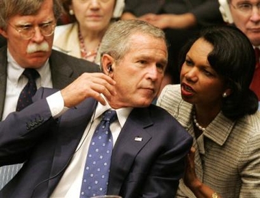 US President Bush turns to Condoleezza Rice, U.S. Secretary of State, during a Security Council meeting at the 2005 World Summit at the United Nations Wednesday, Sept. 14, 2005. At left is John Bolton, U.S. Ambassador to the U.N. [AP]