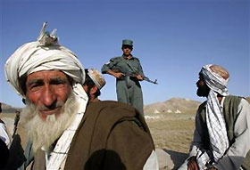 Afghan nomads wait at a polling station on the outskirts of Kabul September 18, 2005. 