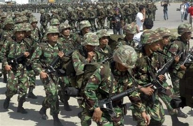 Indonesian soldiers march to board a ship in Lhokseumawe, Aceh, which will take them to their base in Medan, North Sumatra, Indonesia, Sunday, Sept. 18, 2005. 