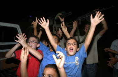 Palestinian youngsters celebrate in the evacuated Jewish settlement of Ganim in the northern West Bank after Israeli troops left the settlement.