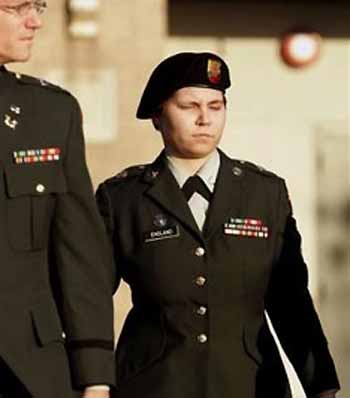 .S. Army Pfc. Lynndie R. England, right, walks out of the courthouse with a member of her defense, Capt. Jonathan Crisp, left, Monday Sept. 26, 2005, in Fort Hood, Texas.