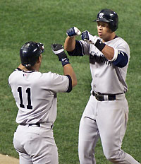New York Yankees batter Alex Rodriguez (R) is greeted by teammate Gary Sheffield (11) after hitting a solo home run off Baltimore Orioles starting pitcher Daniel Cabrera in the sixth inning of their game at Camden Yards in Baltimore, Maryland, September 28, 2005. 