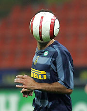 Inter Milan's Luis Figo eyes the ball during the Champions League Group H soccer match against Rangers at the San Siro stadium in Milan September 28, 2005. 