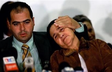 Maria Otoni de Menezes (R), mother of Brazilian man shot dead by British police, is comforted by surviving son Giovanni da Silva during a news conference with close family members at Lambeth Town Hall in south London September 28, 2005.