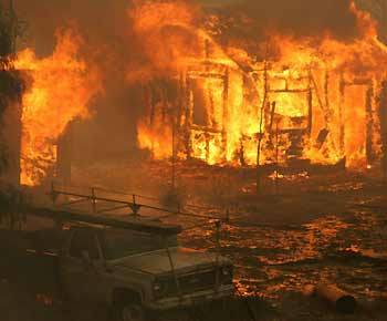 An equipment shed goes up in flames in the West Hills area of Los Angeles September 29, 2005. More than 16,000 acres have burned and hundreds of people have been evacuated as more than 3,000 firefighters battle the wind-whipped blaze northwest of Los Angeles. [Reuters]