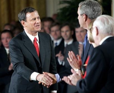 Newly sworn in Chief Justice of the United Supreme Court, John Roberts, shakes the hand of President Bush in the East Room of the White House Thursday, Sept 29, 2005, in Washington.(AP 