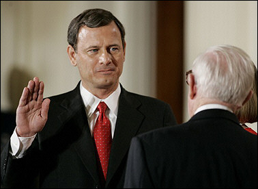 Judge John Roberts(L) is sworn in as US Supreme Court Chief Justice at the White House in Washington, DC by Supreme Court Justice John Paul Stevens a few hours after being confirmed in the Senate(AFP