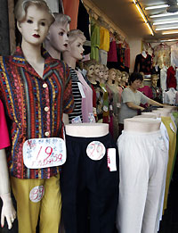 Textile products are on display in a shop in Shanghai September 28, 2005. The United States and China have made "good progress" toward a potential trade deal that could curb billions of dollars in clothing imports from China, but differences remain, U.S. negotiators said on Tuesday. 