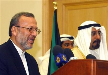 Iran's Foreign Minister Manouchehr Mottaki, left, talks to journalists during a press conference in Kuwait City, Tuesday, Oct.4, 2005, as Kuwait's Minister of Foreign Affairs Sheikh Mohammed Al Sabah, right, looks on.