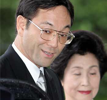 Tokyo metropolitan government worker Yoshiki Kuroda, who will marry Japanese Princess Sayako, daughter of Emperor Akihito, arrives with his mother Sumiko Kuroda at the Imperial Palace in Tokyo for a formal announcement of the date of their matrimony October 5, 2005. The government announced earlier in the year that the couple is to marry on November 15.