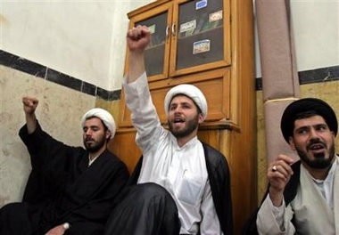 Iranian clerics chant slogans during a demonstration at the Marvi religious school in Tehran to support Iran's nuclear program, on Tuesday Oct. 4, 2005. [AP]