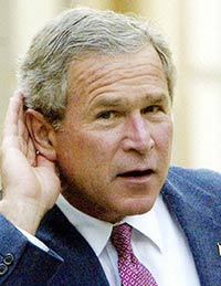 US President George W. Bush cups his ear as reporters in the distance shout to him as he leaves St. John's Episcopal Church in Washintgon, DC, in 2003. Bush allegedly said God told him to invade Iraq and Afghanistan, a new BBC documentary will reveal, according to details. [AFP]