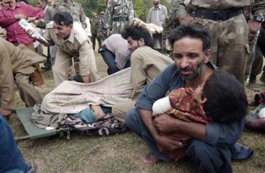 Kashmiris wait with injured children to be airlifted to Srinagar at an army base in Uri, about 100 kilometers (63 miles) north of Srinagar, India, Saturday, Oct. 8, 2005. 