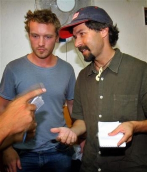 Dion Nissenbaum, right, an American reporter for the Knight Ridder newspaper chain, and British photographer Adam Pletts, left, working on contract for Knight Ridder, speak with a journalist following their release at the Palestinian police headquarters in Gaza city, Wednesday Oct. 12, 2005. 