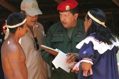 Venezuela's President Hugo Chavez gives land titles to Karina indigenous from Anzoategui state at a ceremony in Barranco Yopal in Venezuela's Apure state, Wednesday, Oct. 12, 2005, on Columbus Day, known in Venezuela as Indigenous Resistance Day. (AP