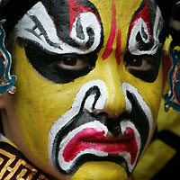 QA Chinese performer sports colourful make-up before the start of the season-ending Chinese Grand Prix in Shanghai October 16, 2005. 