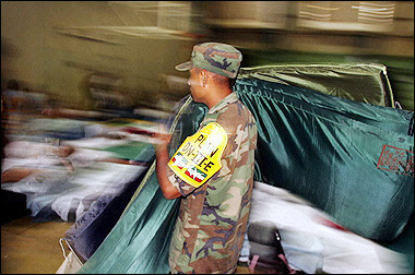 A Mexican soldier carries some mattresses for tourists at a shelter in Cancun, state of Quintana Roo, Mexico.