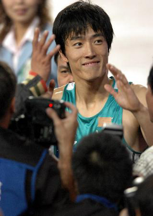 Olympic gold medallist Liu Xiang of China reacts after winning the final of the 110-meter hurdles at the 10th National Games of the People's Republic of China in Nanjing. 