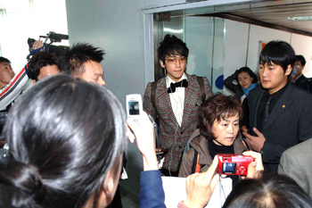 South Korean pop singer Rain arrives at Beijing International Airport on Saturday morning, Oct 22, 2005, with hundreds of crazy fans surrounding him and chanting his name. [newsphoto] 