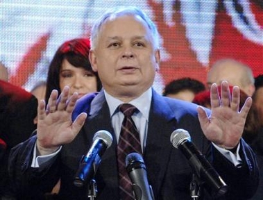 Lech Kaczynski from the Law and Justice party greets his supporters as exit poll results are announced, declaring him the winner in the Polish presidential run-off vote in Warsaw, Poland, Sunday Oct.23, 2005. (AP 