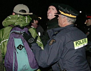 Police push protestors off the road as U.S. Secretary of State Condoleezza Rice arrives for a meeting at Prime Minister Paul Martin's official residence at 24 Sussex Drive in Ottawa, Monday, Oct. 24, 2005 in Canada. (AP