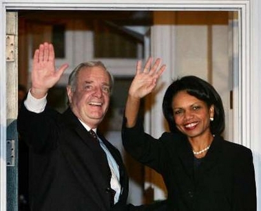 Canadian Prime Minister Paul Martin (L) waves with U.S. Secretary of State Condoleezza Rice from the doorway of his official residence in Ottawa October 24, 2005. Rice is in Ottawa for a two-day official visit.