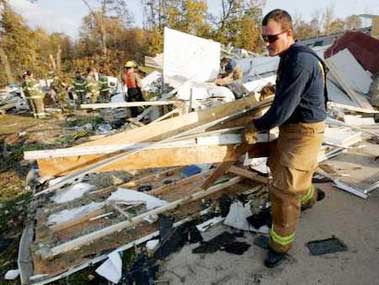 Volunteer firefighter Chad Patterson searches for survivors in the devastated Eastbrook Mobile Home Park in Evansville, Indiana, November 6, 2005. A powerful tornado tore through southern Indiana and parts of Kentucky early on Sunday killing at least 18 people and injuring more than 100, many of whom were sleeping when the twister hit, officials said.