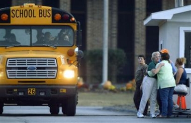A school bus carrying students leaves Campbell County High School after a student shot and killed an assistant principal and seriously wounded two other administrators, according to police, Tuesday, Nov. 8, 2005, in Jacksboro, Tenn. (AP