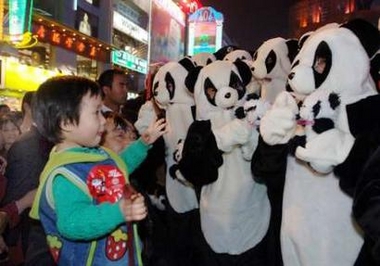Locals celebrate after the panda is chosen to be one of the five mascots for the 2008 Beijing Olympic Games, in Chengdu, southwest China's Sichuan province, November 11, 2005. 