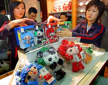 Salesgirls arrange a set of five doll mascots for the 2008 Olympics in a special store in Nanjing, east China's Jiangsu province, November 11, 2005.
