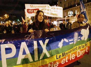 A French student holds a banner reading 'Peace' in a protest against the government's request for a three-month extension of a state of emergency, in Paris, Wednesday Nov. 16, 2005.