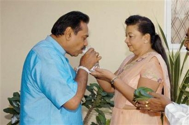 Sri Lanka's Prime Minister Mahinda Rajapakse receives blessing from his wife Shirani before leaving for a polling station in Weeraketiya, 220 km (137 miles) from Colombo November 17, 2005.